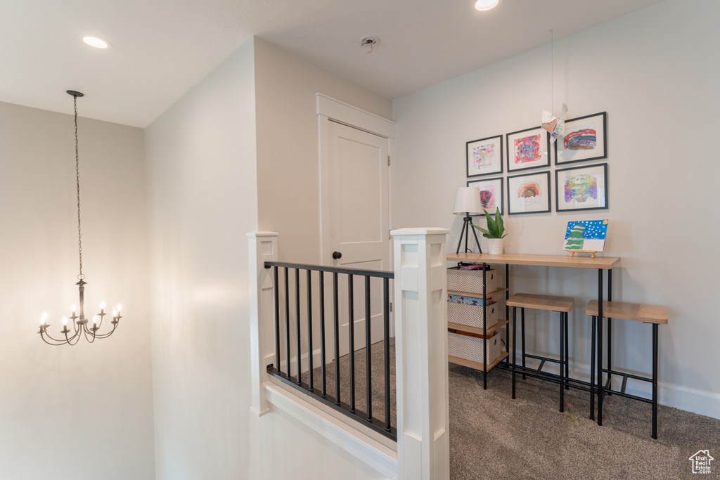 Hallway featuring recessed lighting, an inviting chandelier, carpet flooring, an upstairs landing, and baseboards