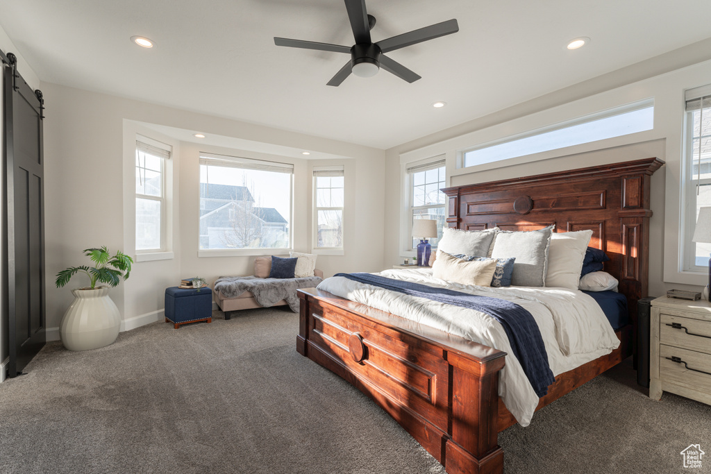 Bedroom with carpet, baseboards, recessed lighting, and a barn door