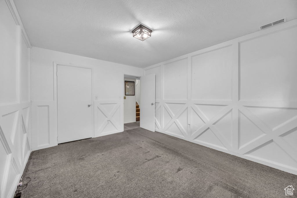 Garage with a decorative wall and visible vents