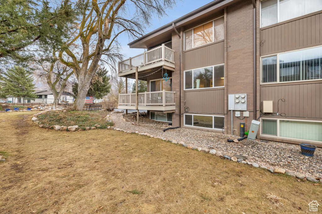 Exterior space with brick siding and a balcony