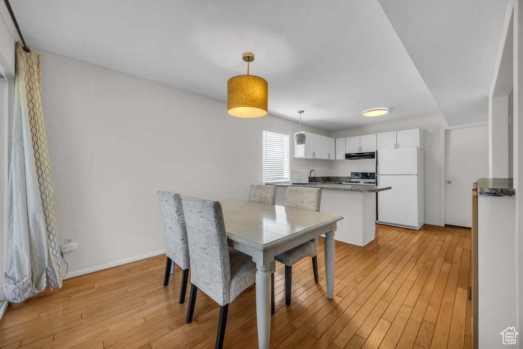 Dining area with light wood finished floors and baseboards