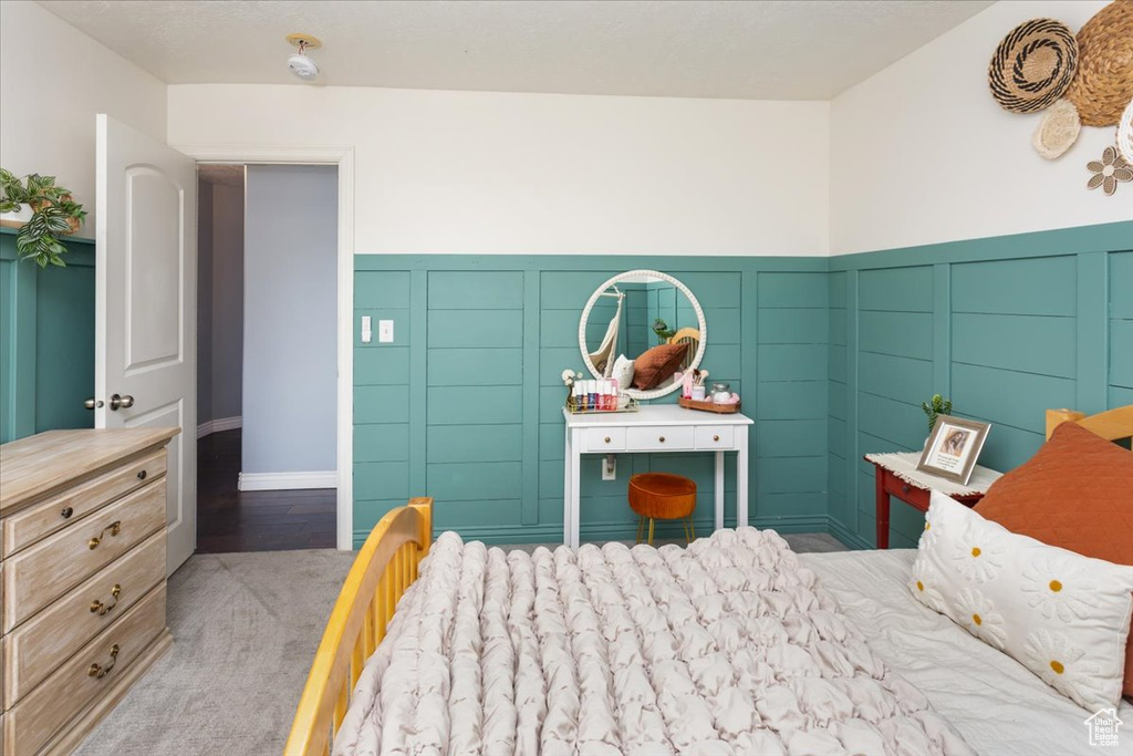 Carpeted bedroom with wainscoting