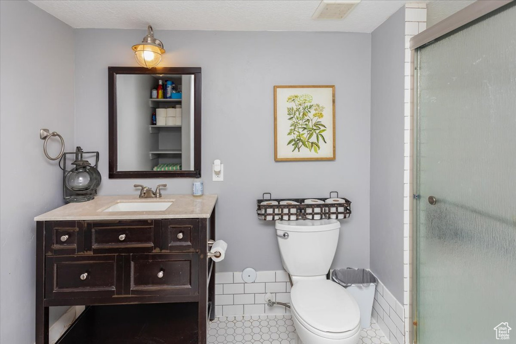 Full bath featuring visible vents, vanity, toilet, and an enclosed shower