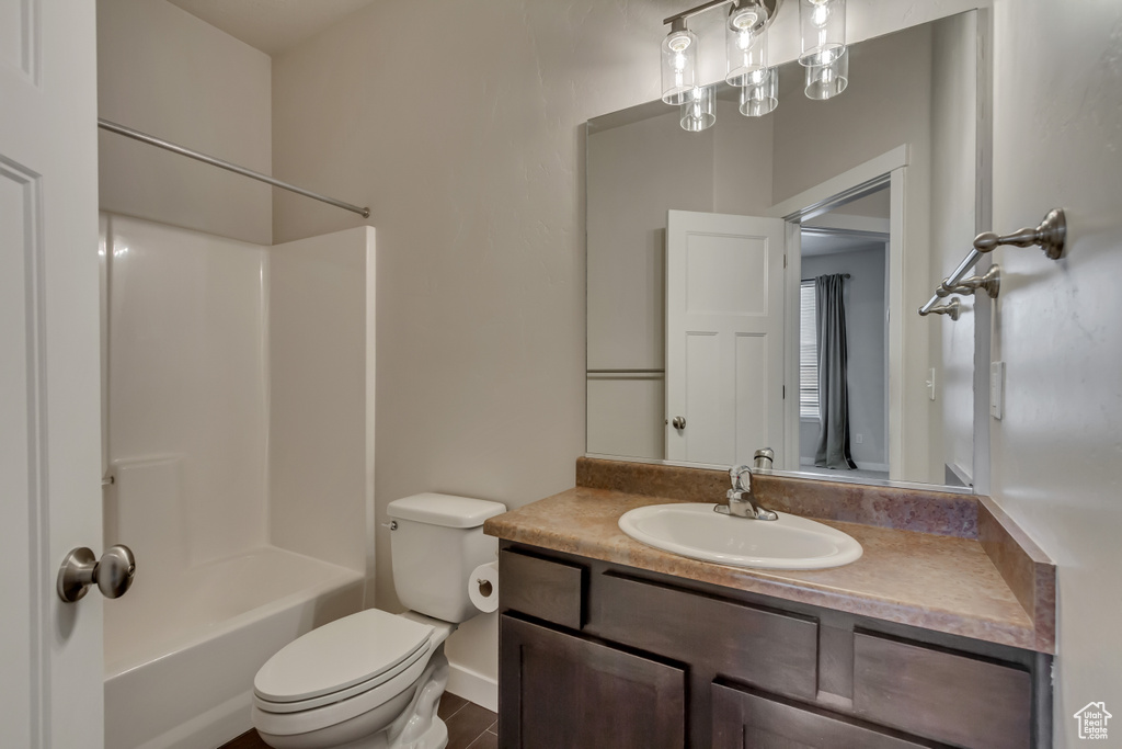 Bathroom with shower / tub combination, vanity, and toilet