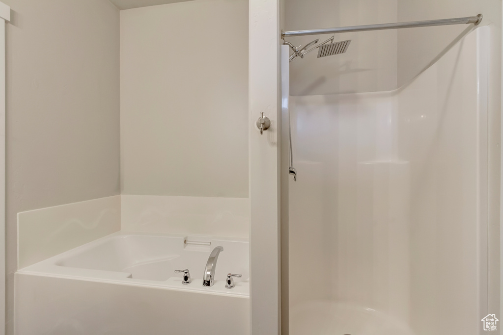 Full bathroom featuring a stall shower and a bath