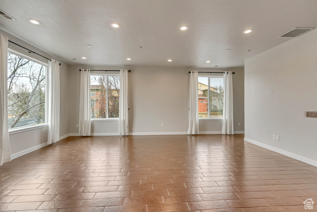 Empty room with baseboards, visible vents, and recessed lighting