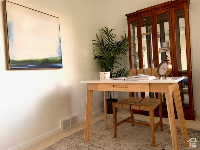 Carpeted office featuring visible vents and baseboards