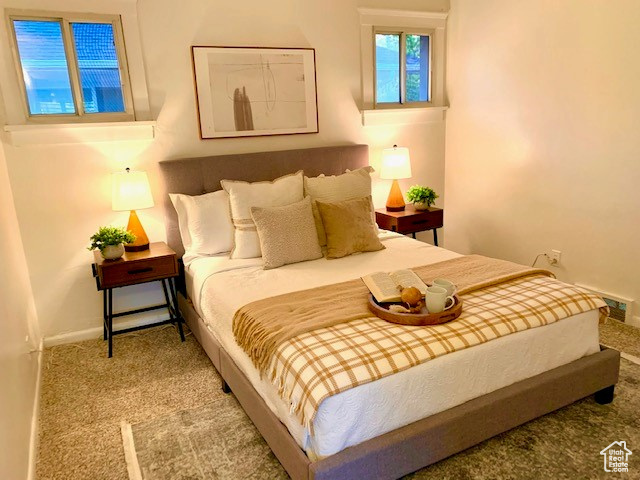 Bedroom with baseboards and carpet flooring