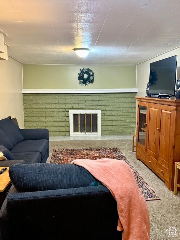 Carpeted living area with a fireplace