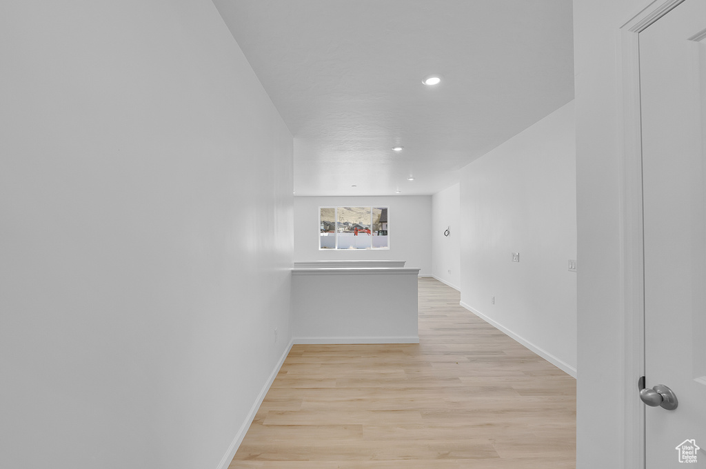 Interior space featuring light wood finished floors, baseboards, and recessed lighting