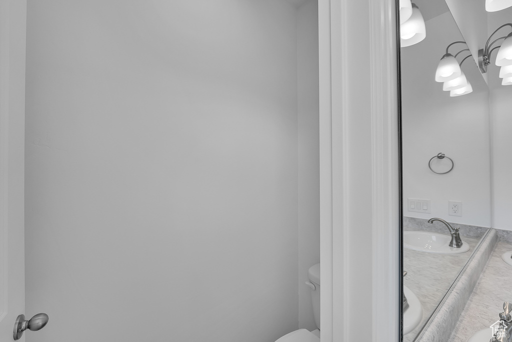 Bathroom featuring double vanity, a sink, and toilet