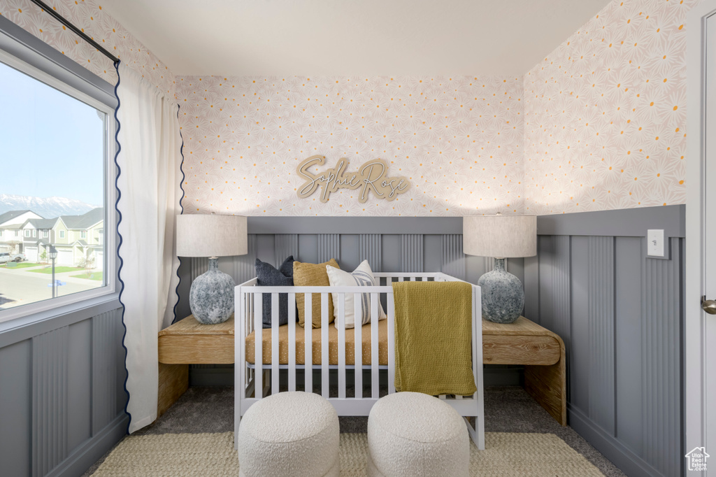 Carpeted bedroom featuring wallpapered walls