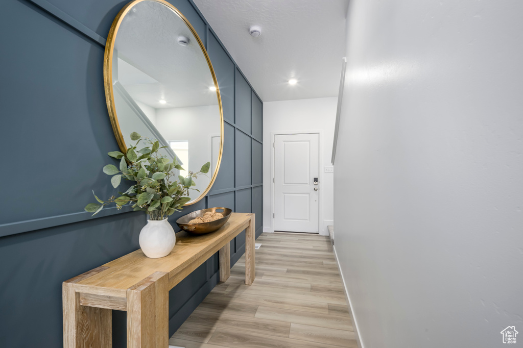 Hall featuring recessed lighting, baseboards, and light wood finished floors
