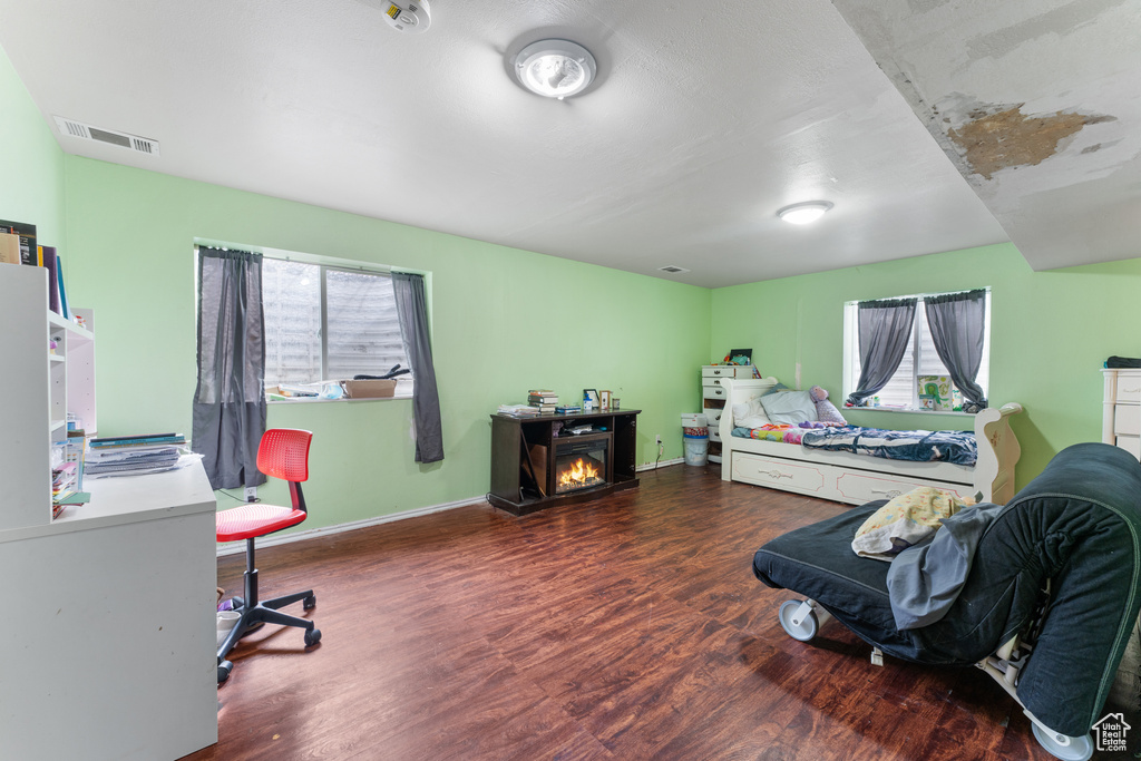 Bedroom featuring baseboards, visible vents, and wood finished floors