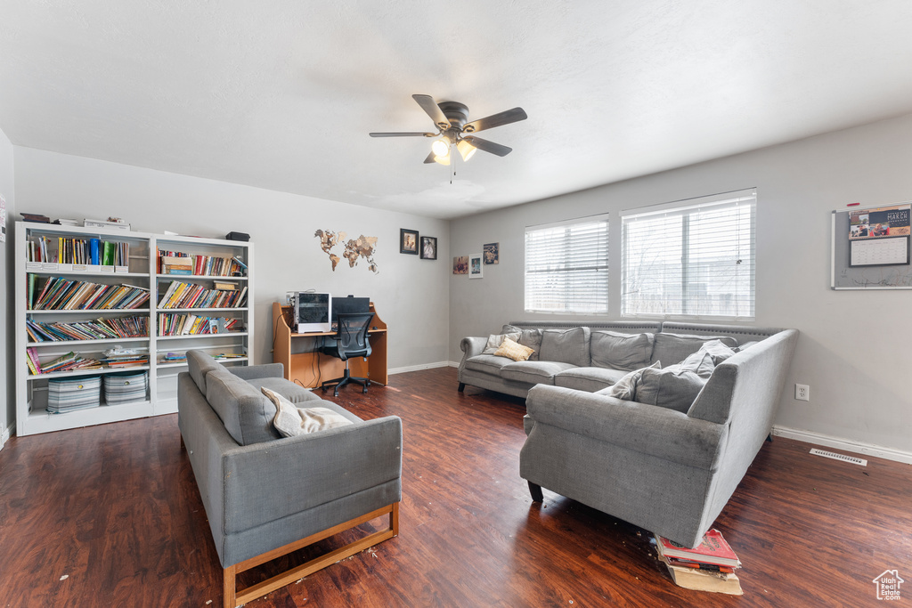 Living area featuring ceiling fan, wood finished floors, visible vents, and baseboards