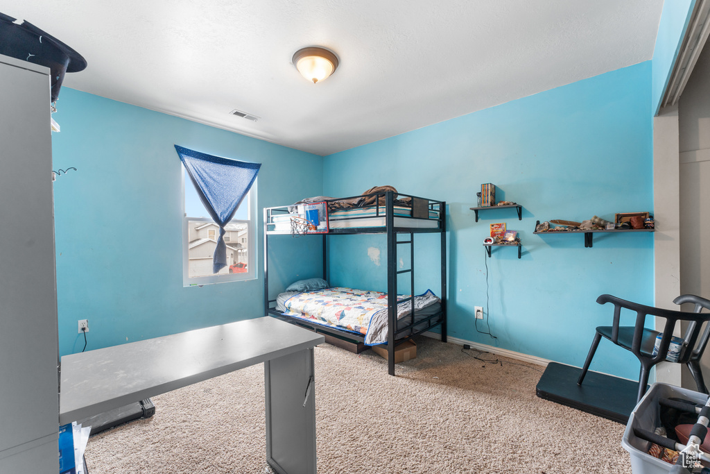 Bedroom featuring carpet, visible vents, and baseboards