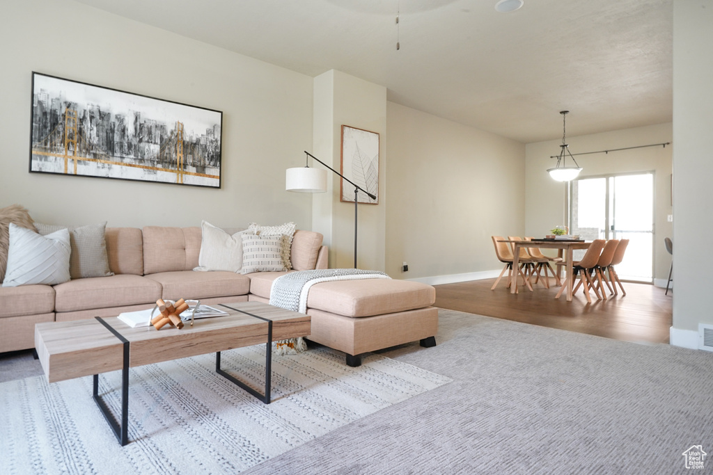 Living area with baseboards and wood finished floors