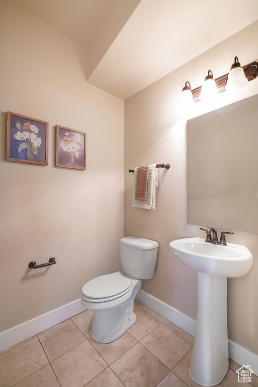 Bathroom with toilet and tile patterned floors