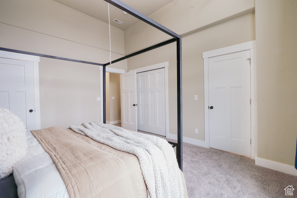 Carpeted bedroom featuring baseboards