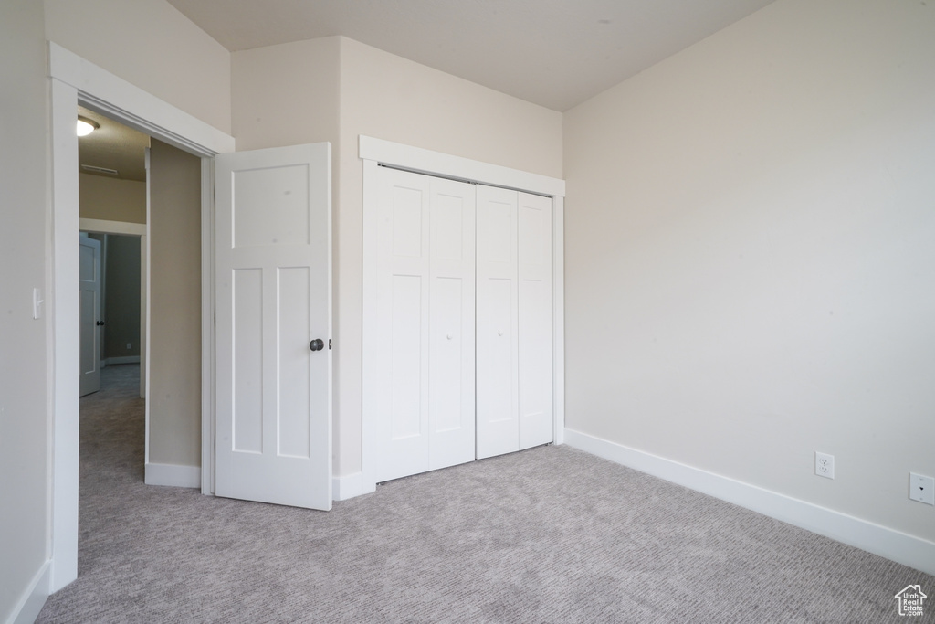 Unfurnished bedroom with carpet floors and a closet