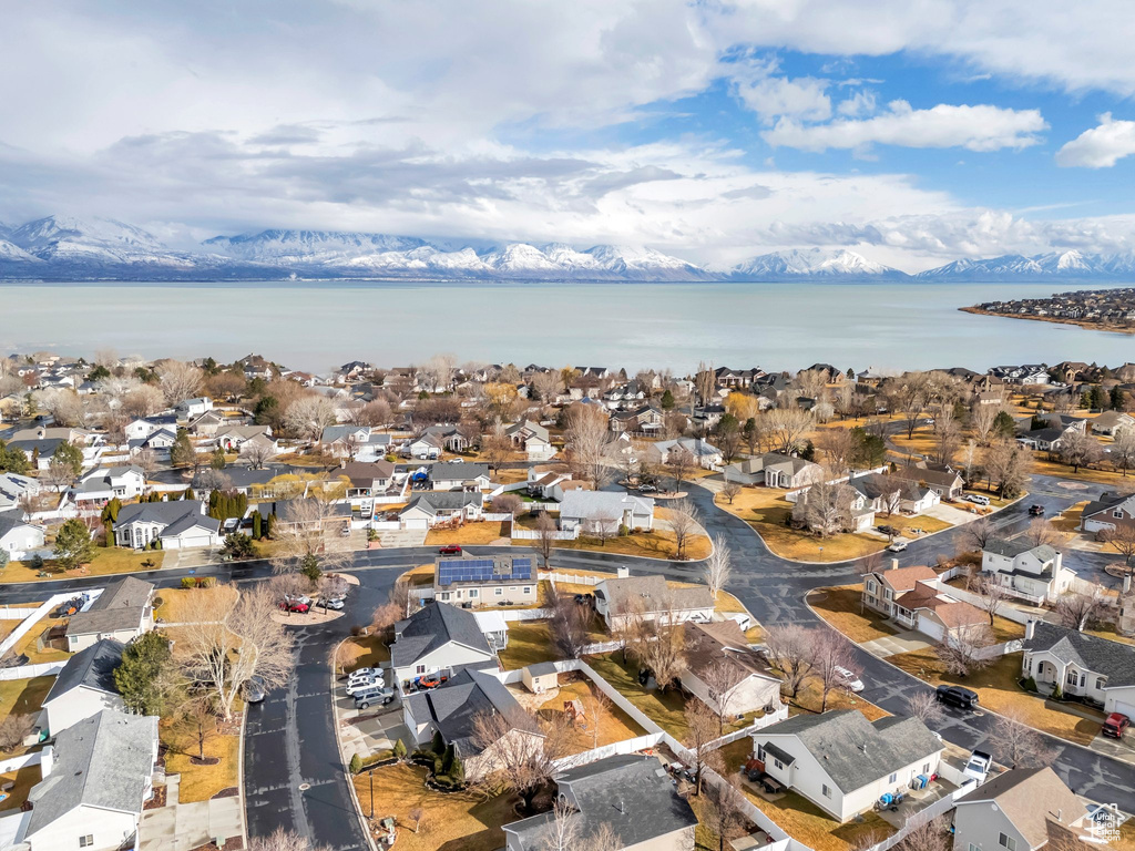 Drone / aerial view featuring a water and mountain view and a residential view