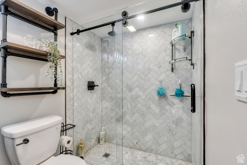 Full bath with a shower stall and toilet