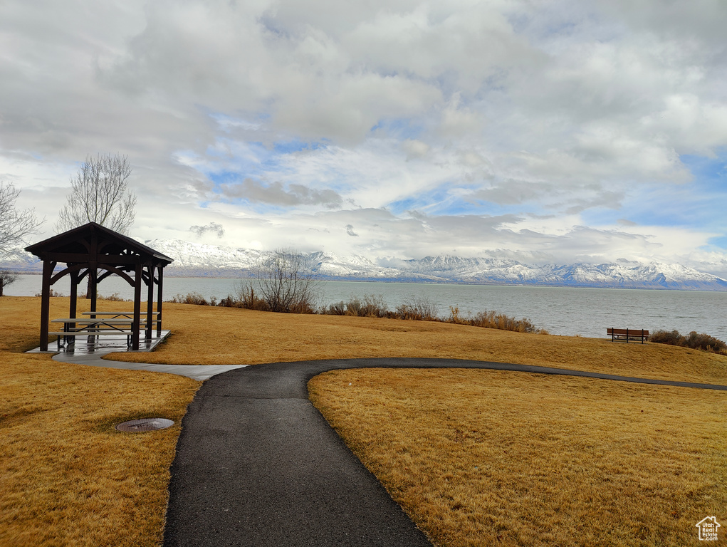 View of community featuring a water view and a lawn