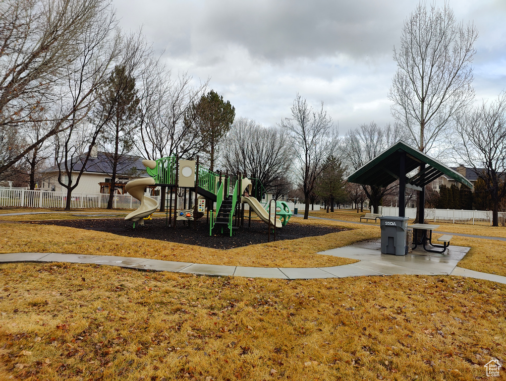 Community playground with a yard and fence