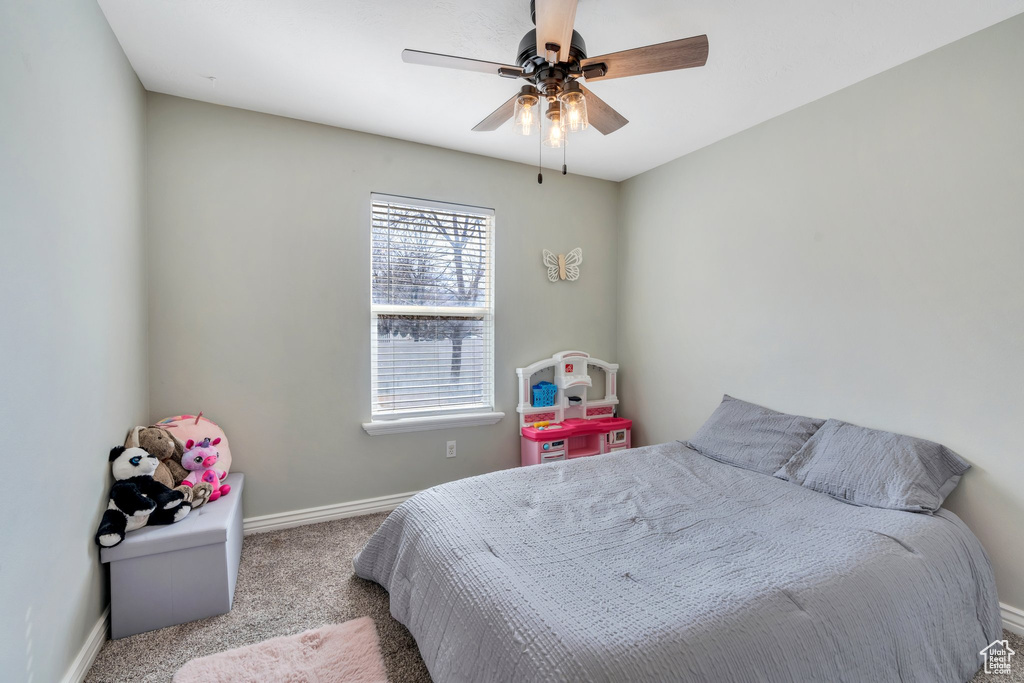 Bedroom featuring carpet floors, a ceiling fan, and baseboards