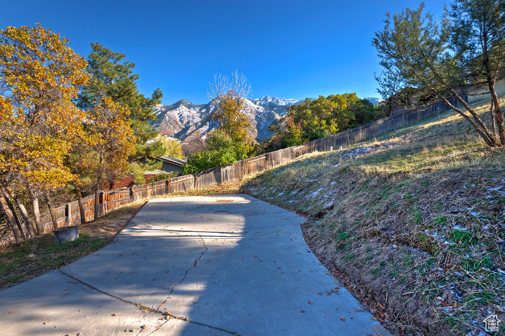 Exterior space with a patio area, fence, and a mountain view