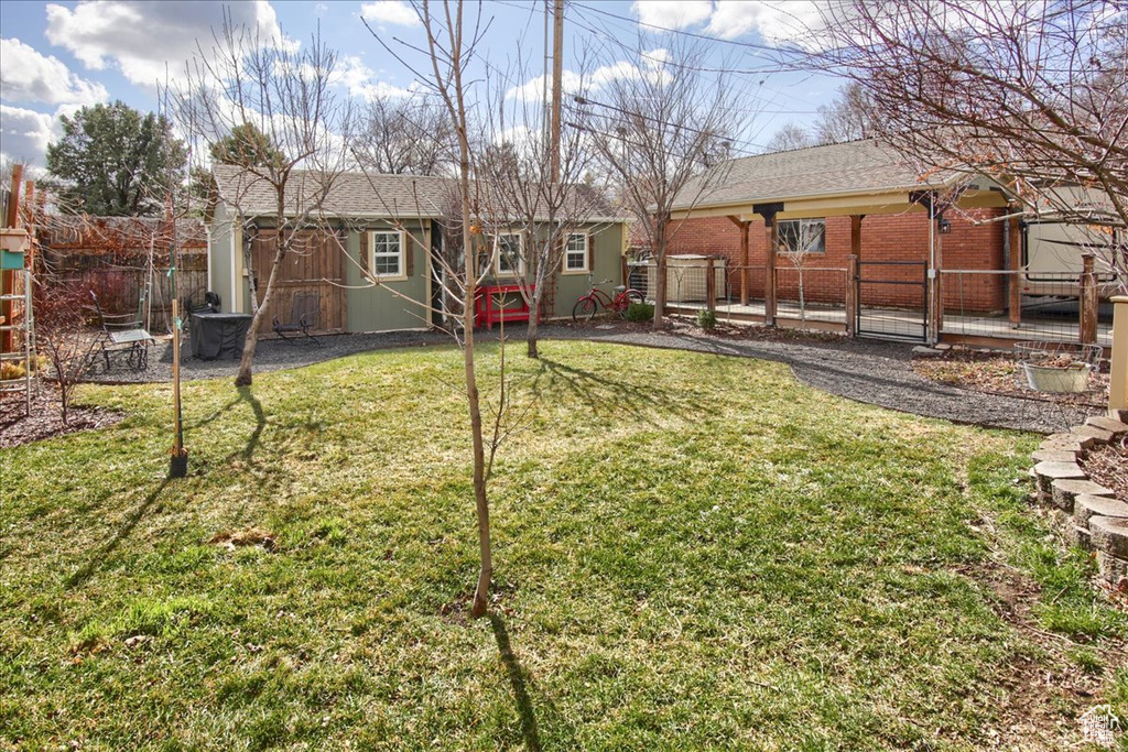 View of yard featuring fence and an outdoor structure