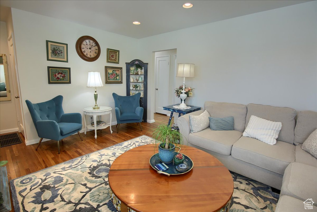 Living area with recessed lighting, baseboards, and wood finished floors