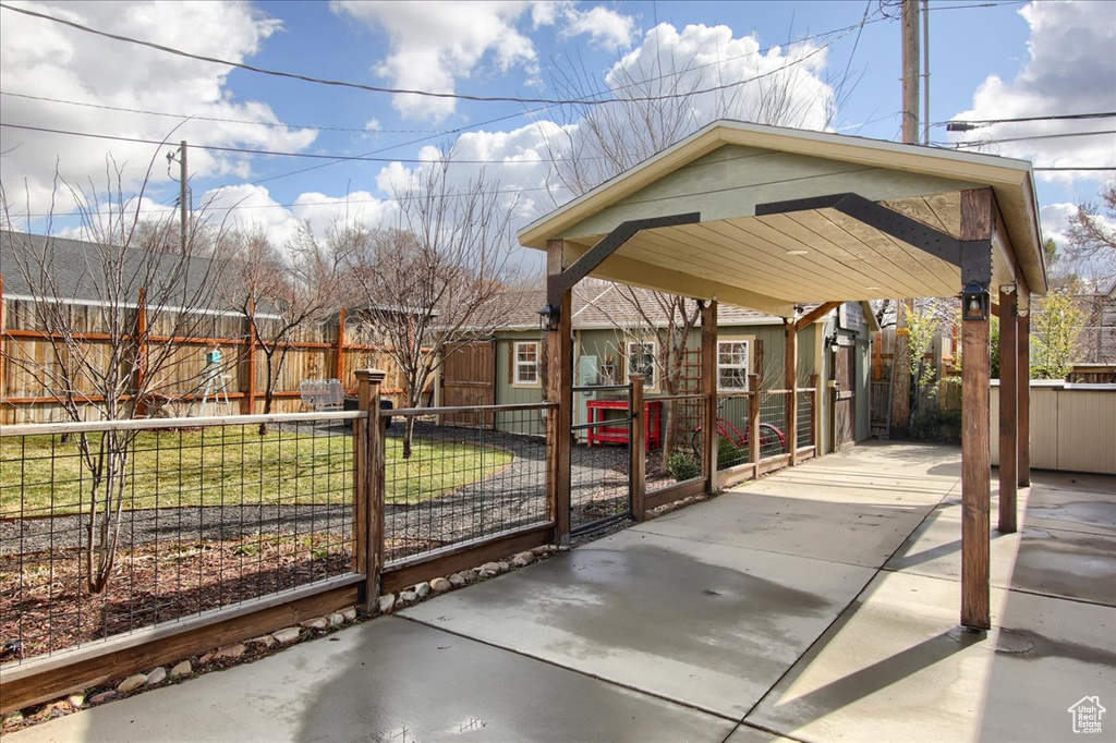 View of home's community with fence private yard and a carport