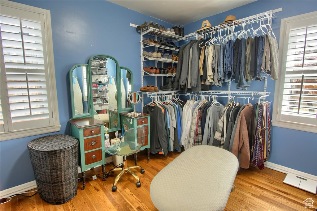 Walk in closet with wood finished floors