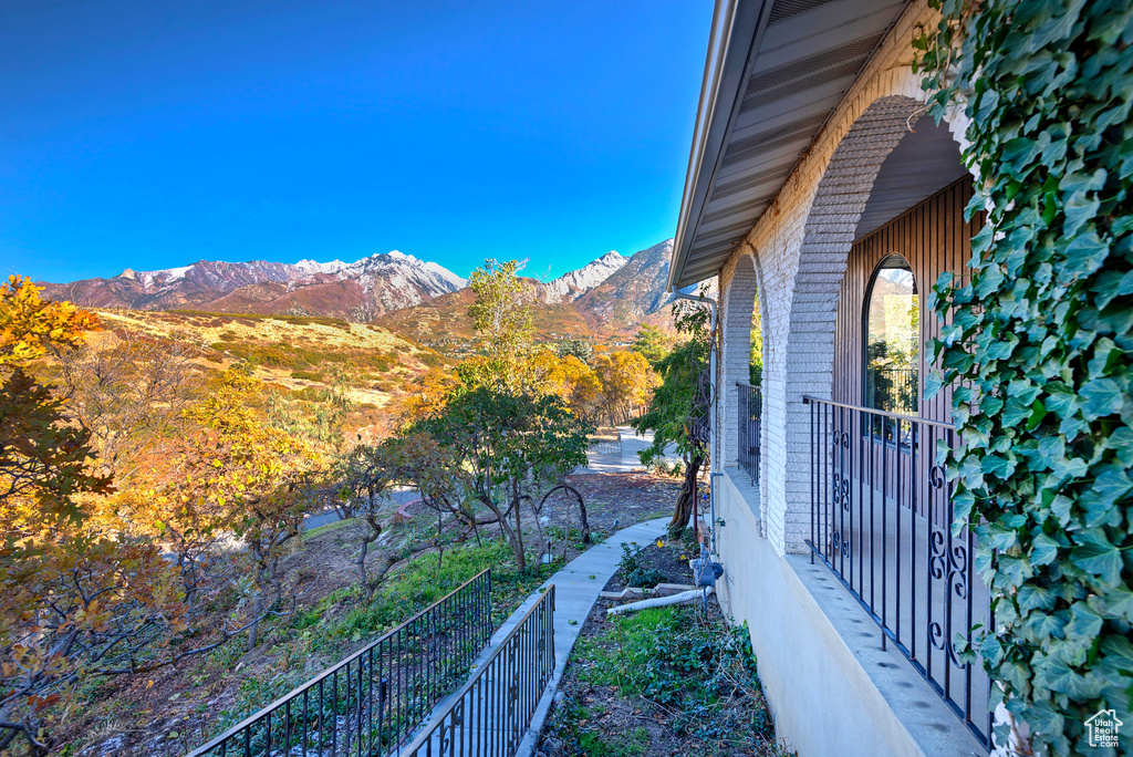 View of side of property with brick siding and a mountain view