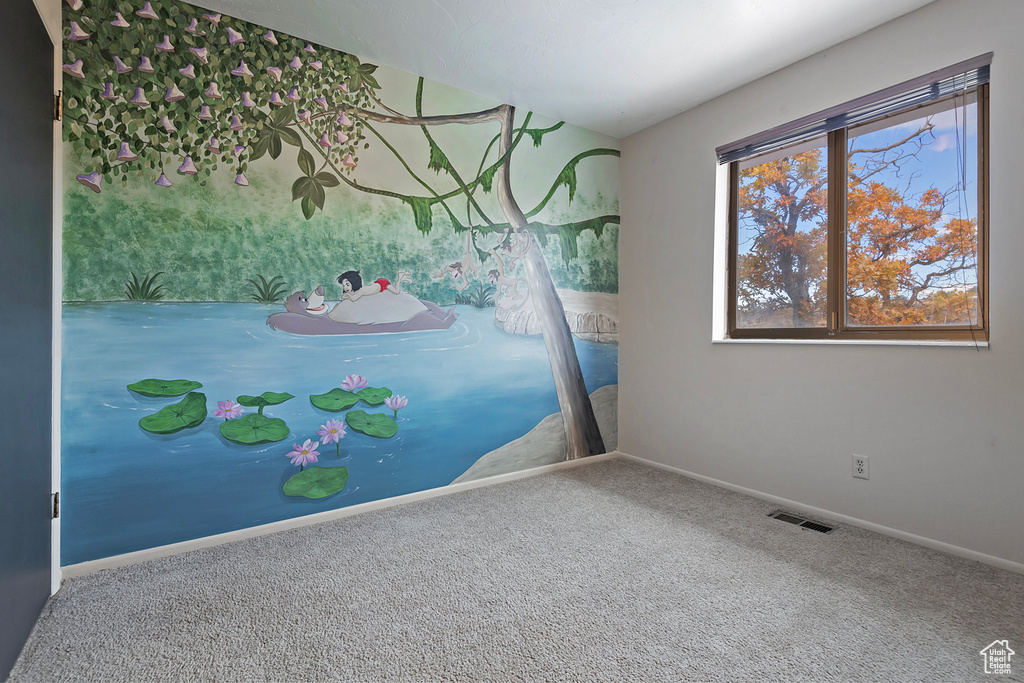 Unfurnished bedroom featuring carpet floors, visible vents, and baseboards