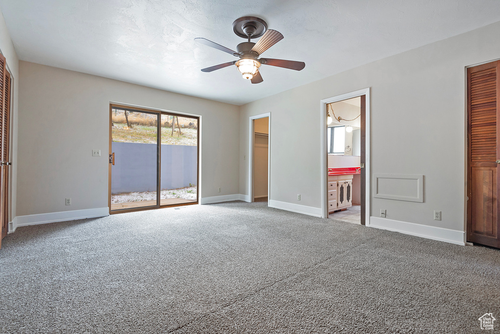 Unfurnished bedroom featuring light carpet, baseboards, and access to exterior