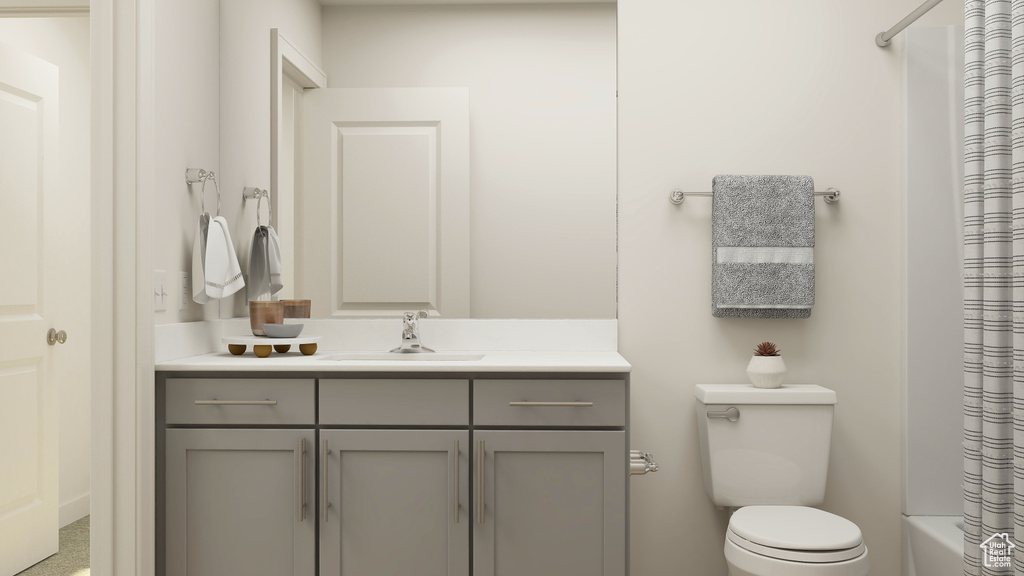 Bathroom featuring toilet, shower / tub combo with curtain, and vanity