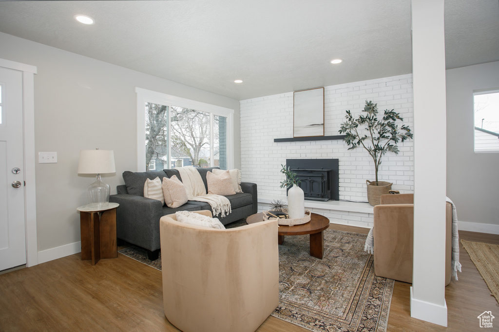 Living area featuring recessed lighting, baseboards, and wood finished floors