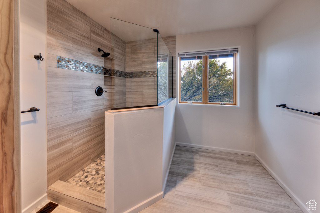 Full bathroom with visible vents, baseboards, and walk in shower