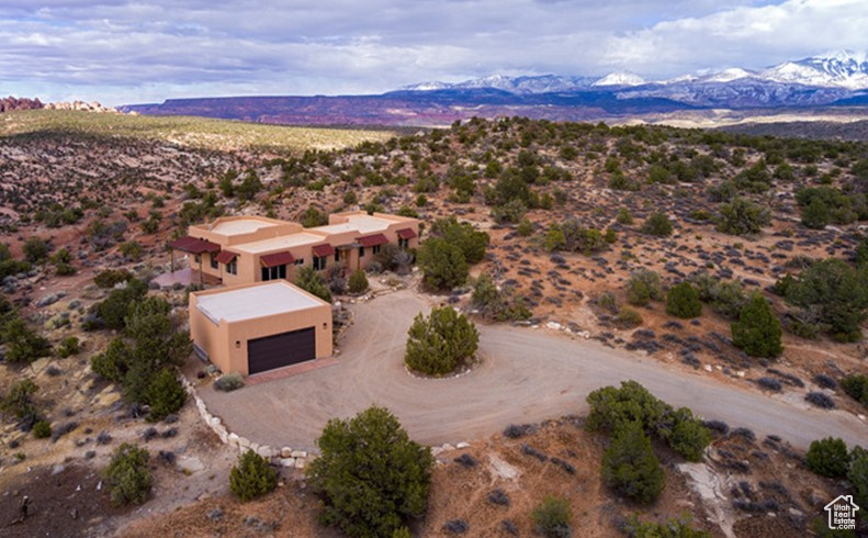 Birds eye view of property with a desert view and a mountain view