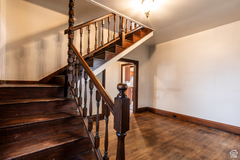 Stairs featuring wood-type flooring and baseboards