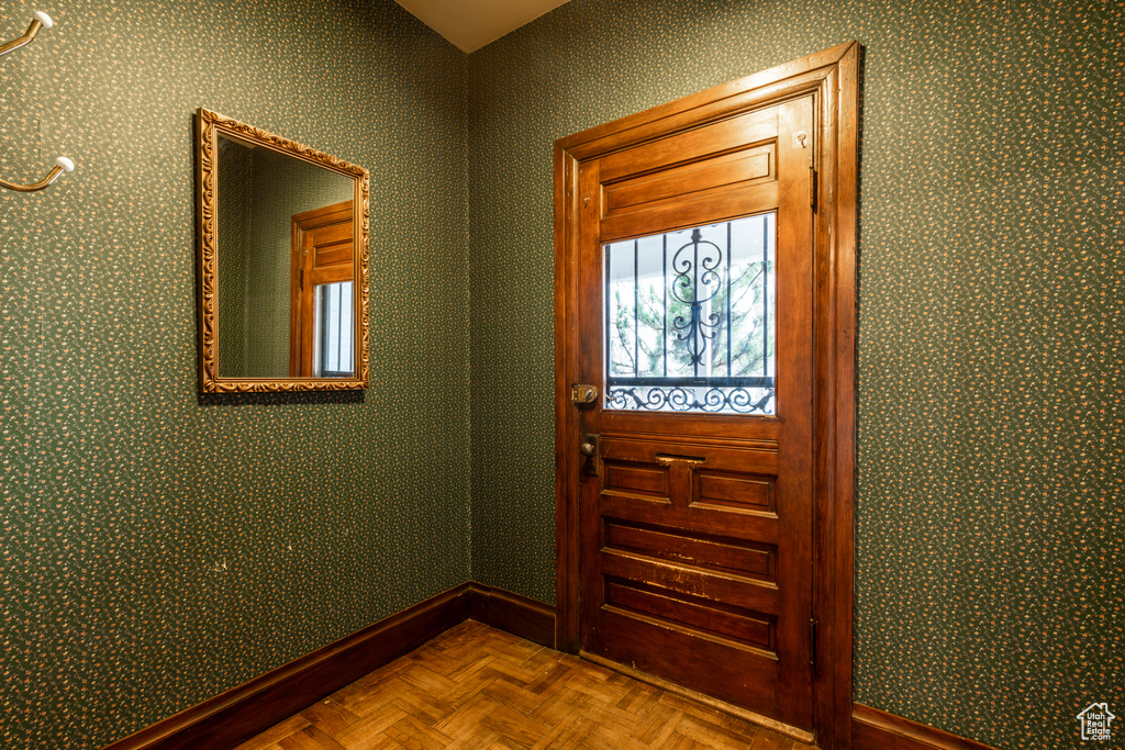 Doorway to outside with baseboards