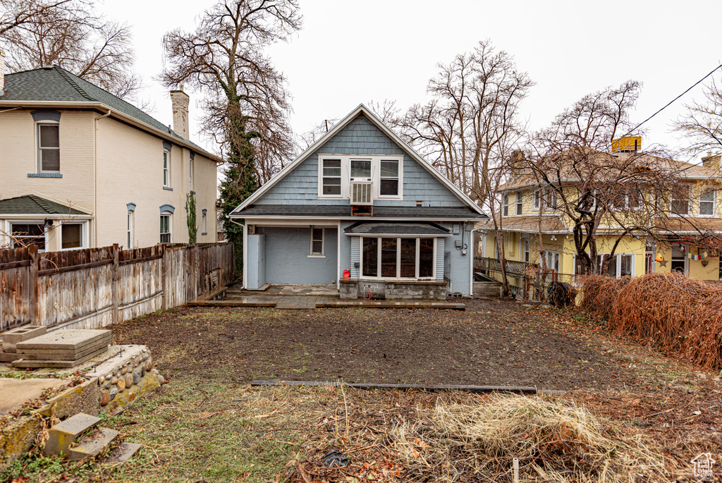 Back of house with a fenced backyard