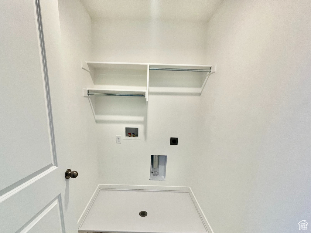 Laundry area featuring light floors, laundry area, baseboards, electric dryer hookup, and washer hookup