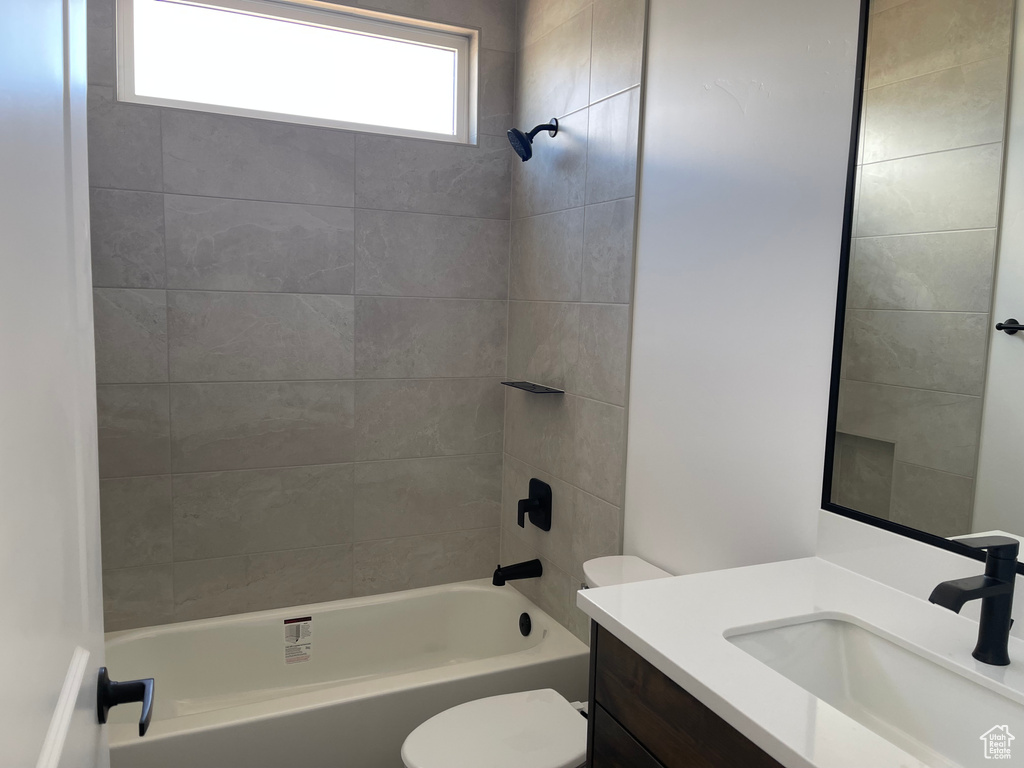 Full bath featuring toilet, vanity, and shower / bathtub combination