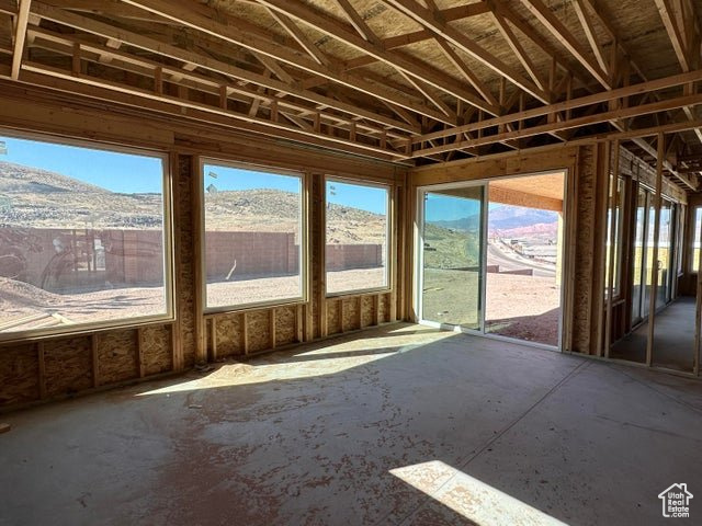 Misc room with a sunroom, a healthy amount of sunlight, and a mountain view