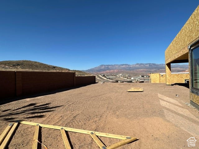 View of yard featuring fence and a mountain view