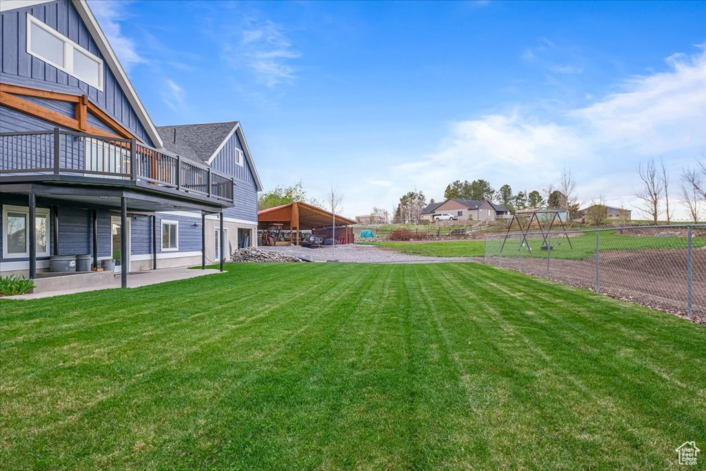 View of yard with fence and a patio