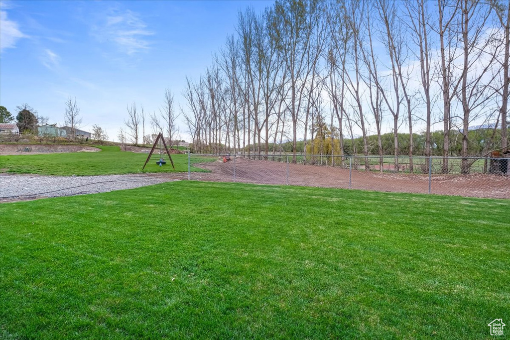 View of property\\\'s community featuring fence and a lawn